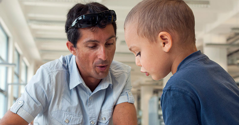 Man teaching a boy