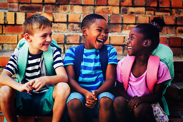 Three kids smiling and laughing