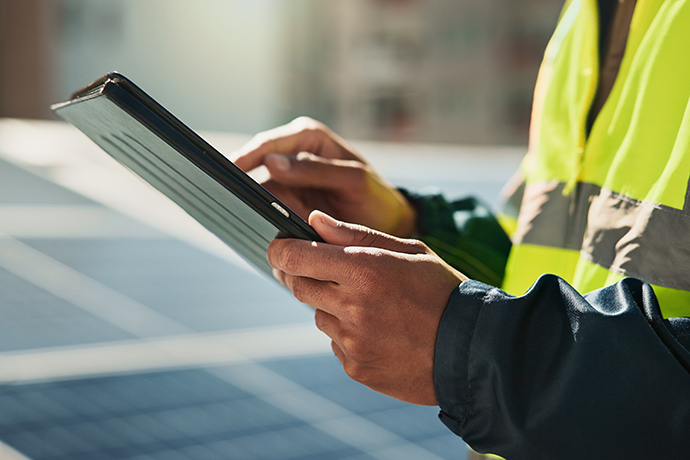 Solar panels, hand and tablet with person in city for photovoltaic grid, technician and engineer. Renewable energy, power generator and inspection with closeup for contractor and maintenance