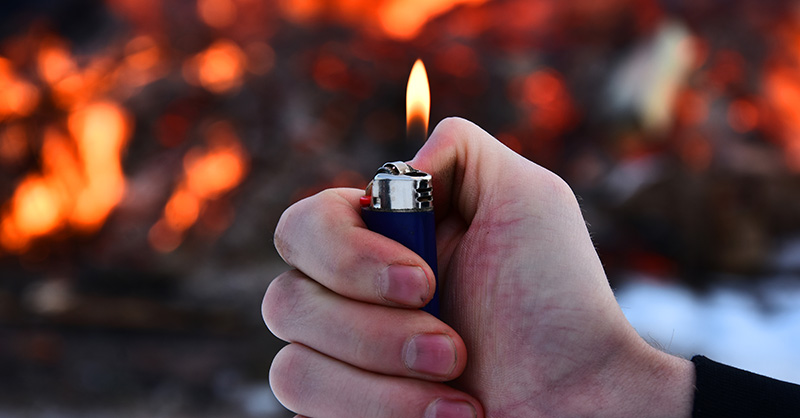 Individual setting business property on fire