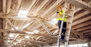 Construction worker on portable ladder