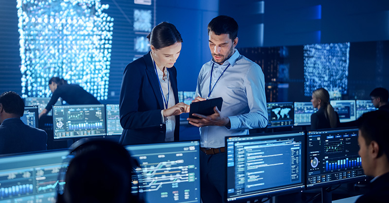 Cyber security professionals viewing analytics in control center