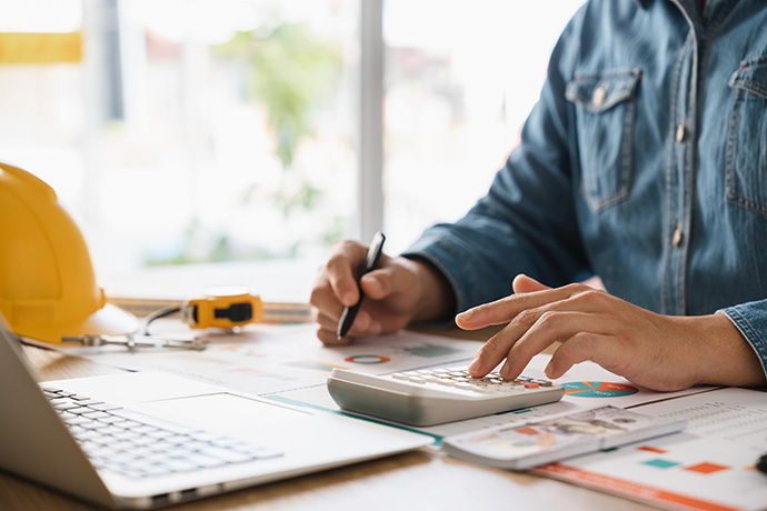 Businessmen are planning budgets for construction projects, analyzing company financial statements, managing global construction project costs. Businessmen are planning budgets for construction projects, analyzing company financial statements, managing global construction project costs.