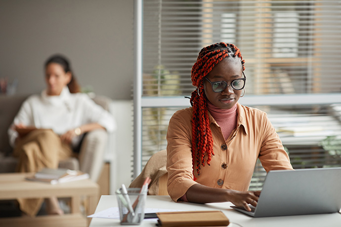 Businesswoman performing research on a laptop